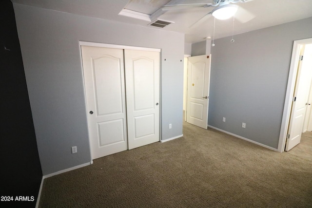 unfurnished bedroom featuring carpet floors, ceiling fan, and a closet