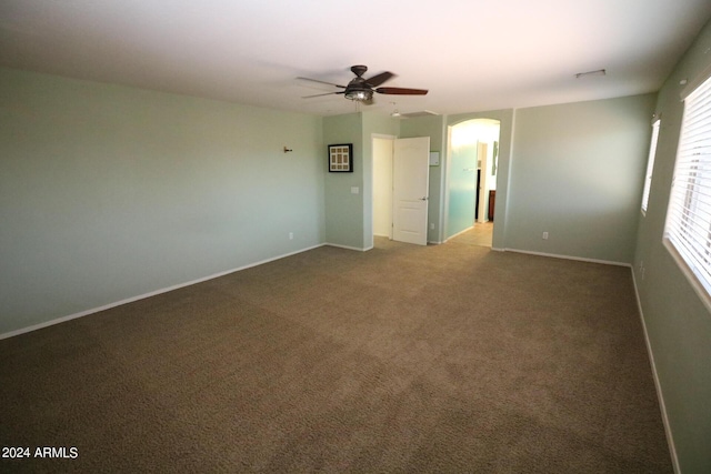 spare room with ceiling fan and carpet