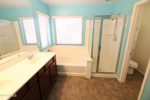 full bathroom featuring independent shower and bath, vanity, tile patterned floors, and toilet