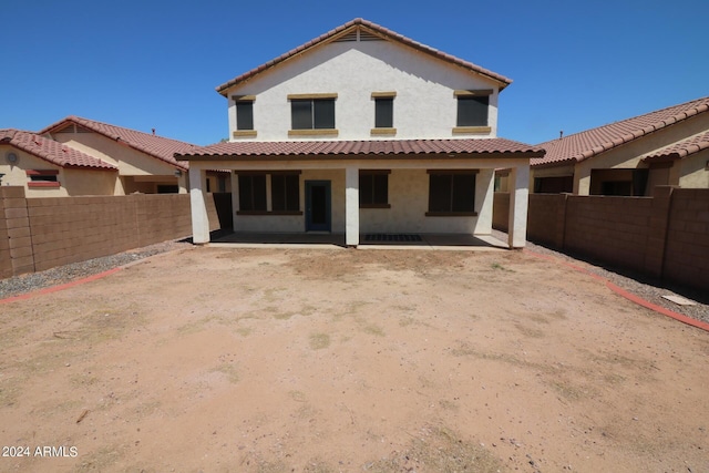 rear view of property featuring a patio area