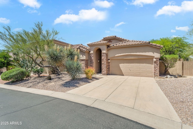 mediterranean / spanish-style house with a garage, stucco siding, driveway, and stone siding