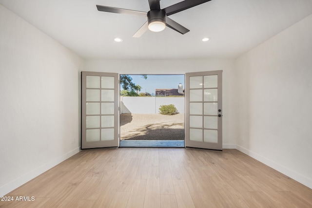 unfurnished room with french doors, light hardwood / wood-style flooring, and ceiling fan