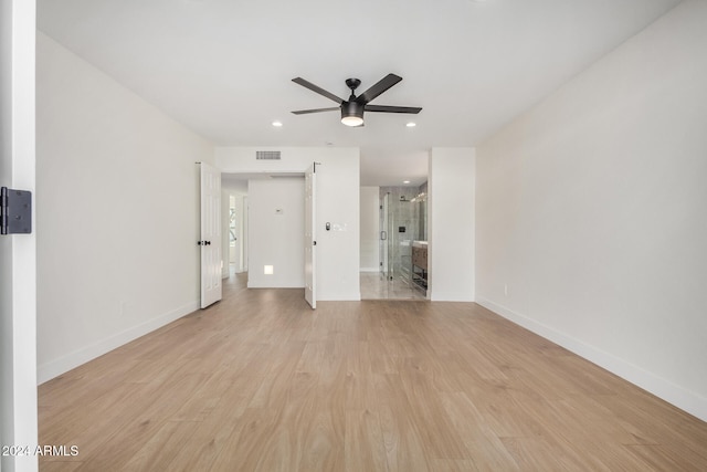 unfurnished living room with light wood-type flooring and ceiling fan