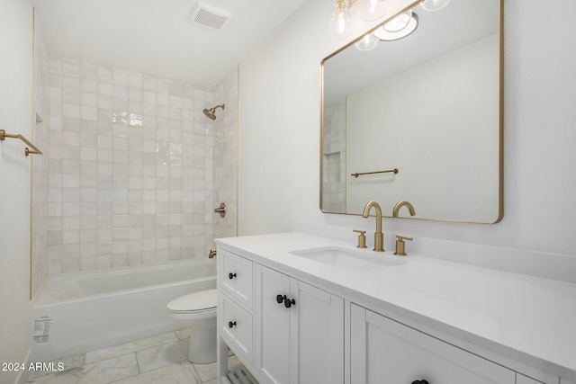 full bathroom with vanity, toilet, and tiled shower / bath