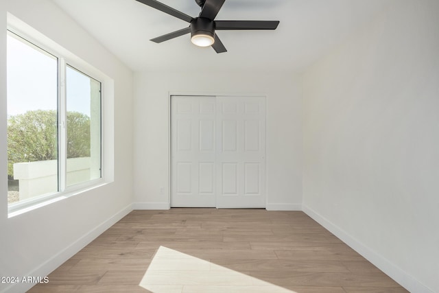 spare room featuring ceiling fan and light hardwood / wood-style flooring