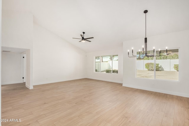 unfurnished living room with ceiling fan with notable chandelier, high vaulted ceiling, and light hardwood / wood-style flooring