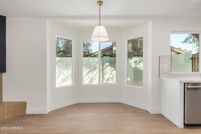 unfurnished dining area featuring light hardwood / wood-style floors