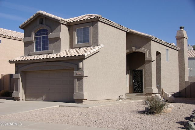 mediterranean / spanish-style house with a garage