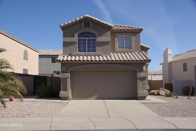 mediterranean / spanish-style home with a garage