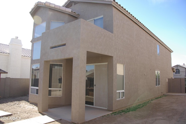 back of property with a patio