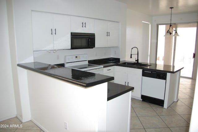 kitchen featuring kitchen peninsula, pendant lighting, white appliances, and sink