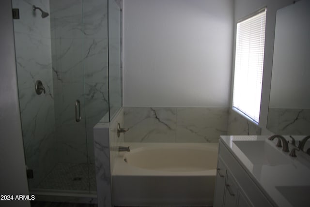 bathroom featuring vanity and shower with separate bathtub