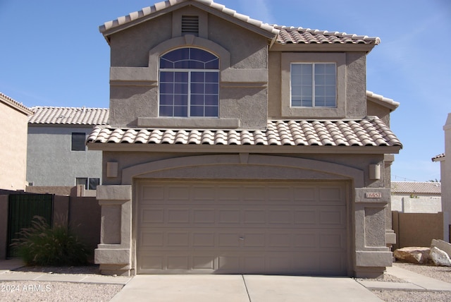 mediterranean / spanish home with a garage