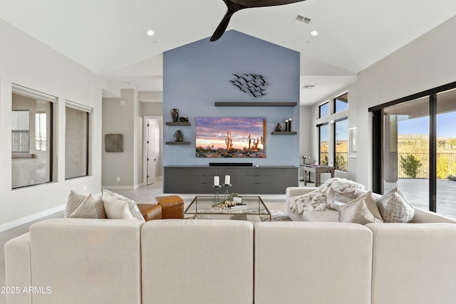 living room featuring ceiling fan and high vaulted ceiling