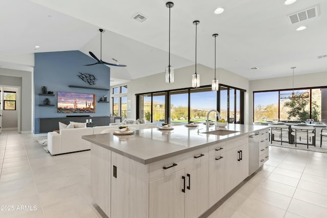 kitchen with a large island with sink, pendant lighting, and sink