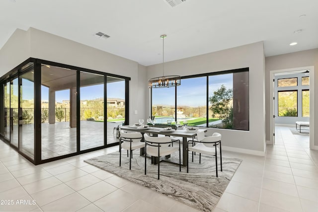 tiled dining area featuring a notable chandelier