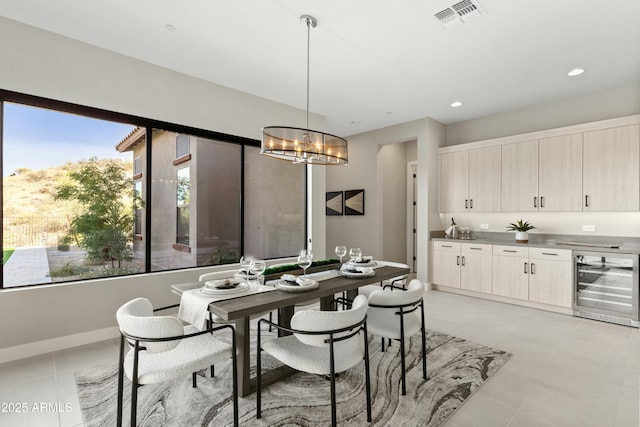 tiled dining area with a wealth of natural light, beverage cooler, and a notable chandelier