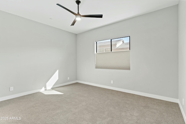 spare room featuring ceiling fan and light colored carpet