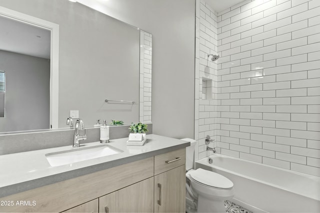 full bathroom with vanity, toilet, and tiled shower / bath