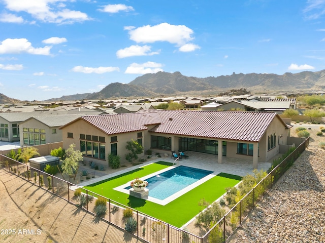 rear view of property with a mountain view and a patio