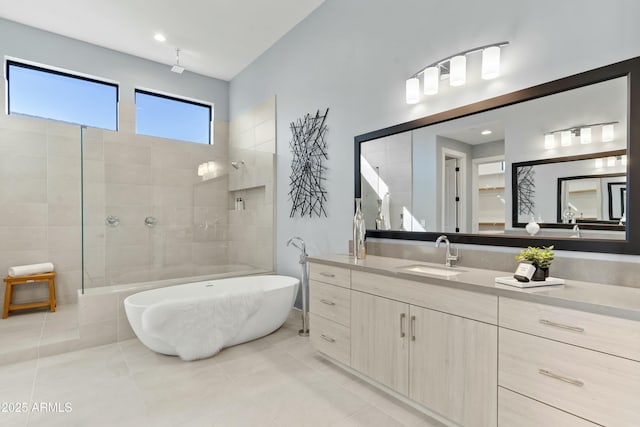 bathroom with tile patterned flooring, shower with separate bathtub, and vanity