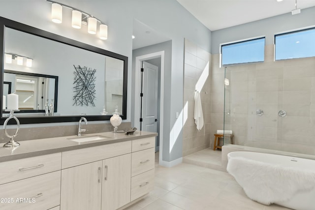 bathroom featuring tile patterned floors, vanity, and tiled shower