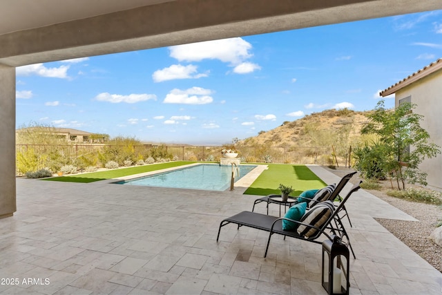 view of pool featuring a mountain view, a yard, and a patio