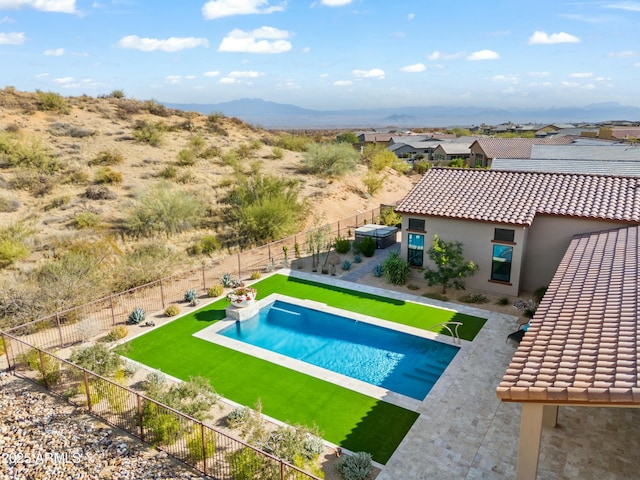 view of pool with a lawn, a mountain view, and a patio