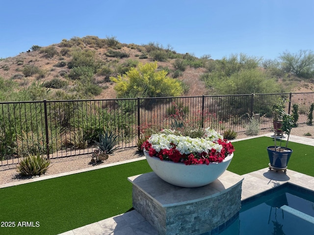 view of yard with a fenced in pool