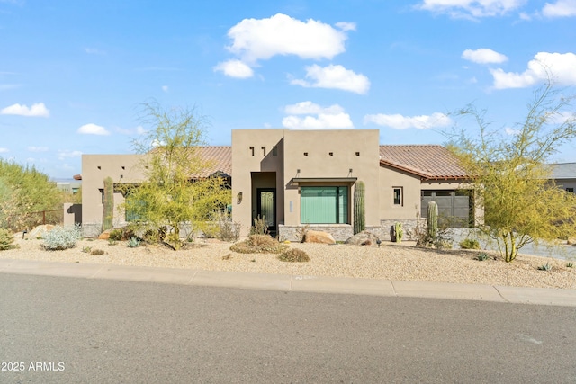 southwest-style home featuring a garage