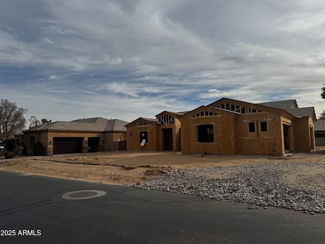 property in mid-construction featuring an attached garage, stucco siding, and driveway