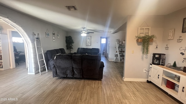 living room featuring ceiling fan and light hardwood / wood-style flooring