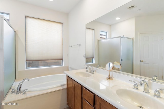 full bath with a stall shower, visible vents, a sink, and a garden tub