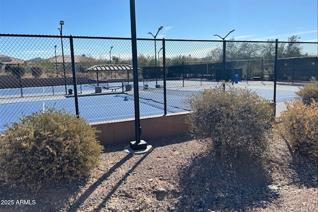 view of sport court featuring fence