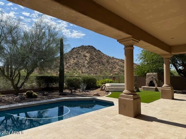 view of pool featuring a patio and a mountain view