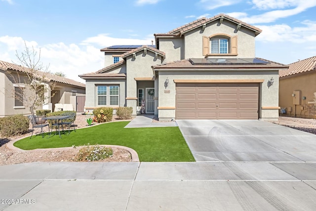 view of front facade featuring a garage, a front yard, and solar panels