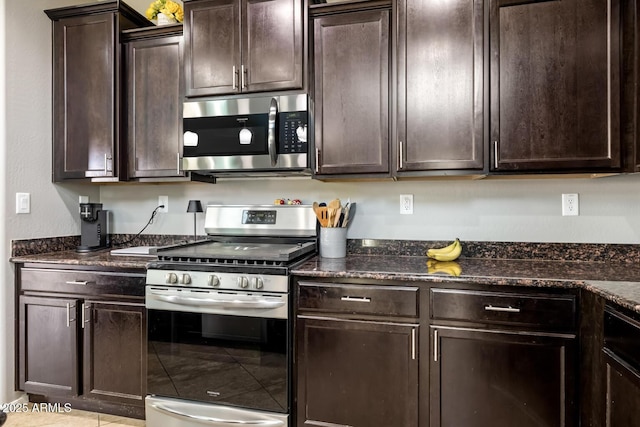 10840 W Saddlehorn Rd, Peoria, AZ 85383 - kitchen with dark brown cabinetry, stainless steel appliances, and dark stone counters