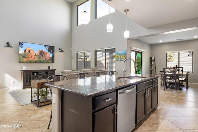 10840 W Saddlehorn Rd, Peoria, AZ 85383 - kitchen featuring a kitchen island with sink, sink, stainless steel dishwasher, and stone counters
