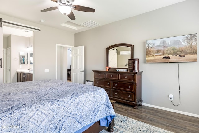 10840 W Saddlehorn Rd, Peoria, AZ 85383 - bedroom with ensuite bathroom, an AC wall unit, dark hardwood / wood-style floors, ceiling fan, and a barn door
