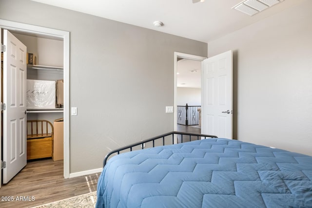 10840 W Saddlehorn Rd, Peoria, AZ 85383 - bedroom with hardwood / wood-style floors and a walk in closet