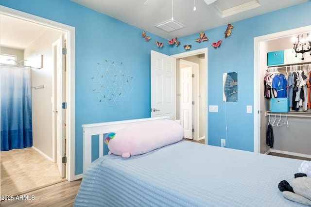 10840 W Saddlehorn Rd, Peoria, AZ 85383 - bedroom with hardwood / wood-style floors, a walk in closet, a closet, and ceiling fan