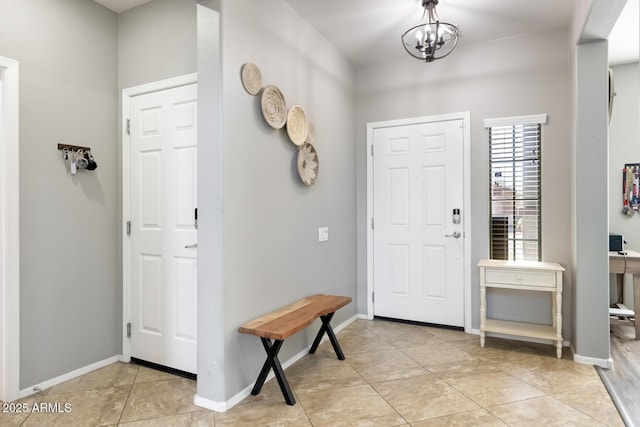 10840 W Saddlehorn Rd, Peoria, AZ 85383 - foyer entrance with light tile patterned flooring and a chandelier