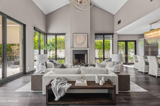 living room with dark hardwood / wood-style flooring, french doors, high vaulted ceiling, and a notable chandelier