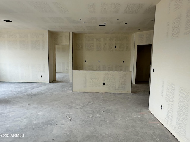 unfurnished room featuring concrete flooring