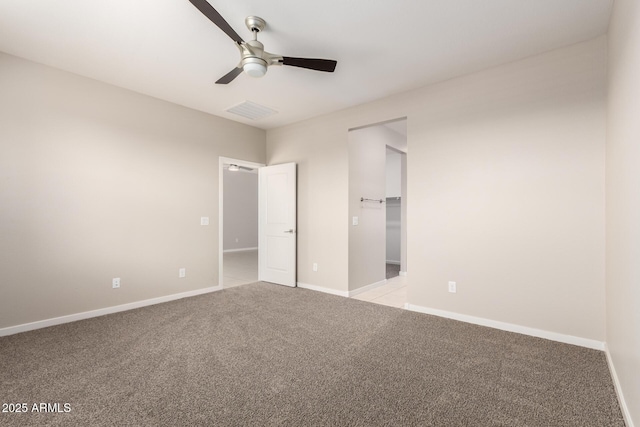 14355 W Valentine St, Surprise, AZ 85379 - unfurnished bedroom featuring visible vents, baseboards, ceiling fan, and light carpet