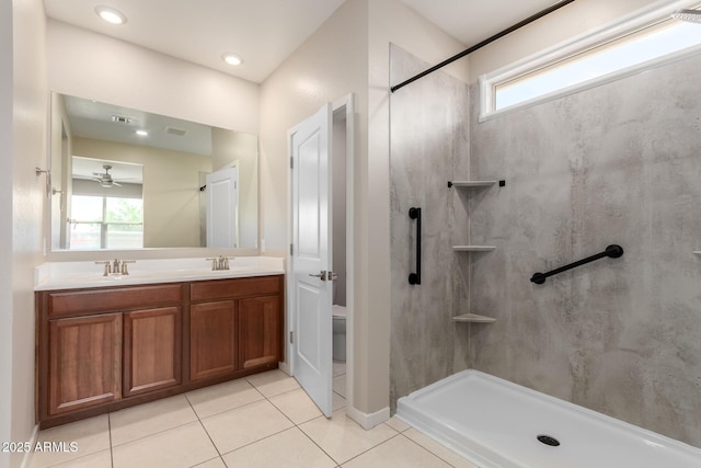 14355 W Valentine St, Surprise, AZ 85379 - bathroom with walk in shower, a sink, toilet, double vanity, and tile patterned floors