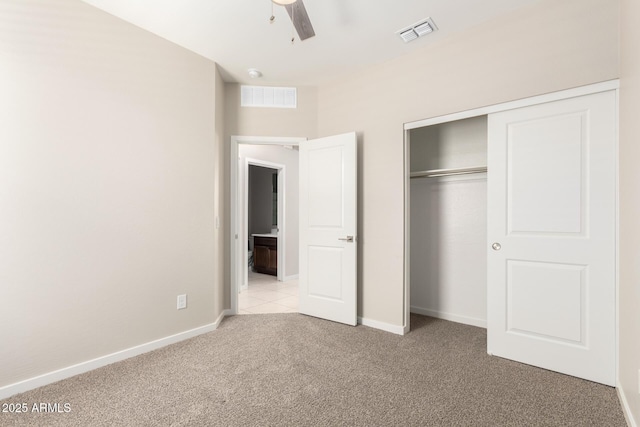 14355 W Valentine St, Surprise, AZ 85379 - unfurnished bedroom featuring light colored carpet, baseboards, visible vents, and a closet