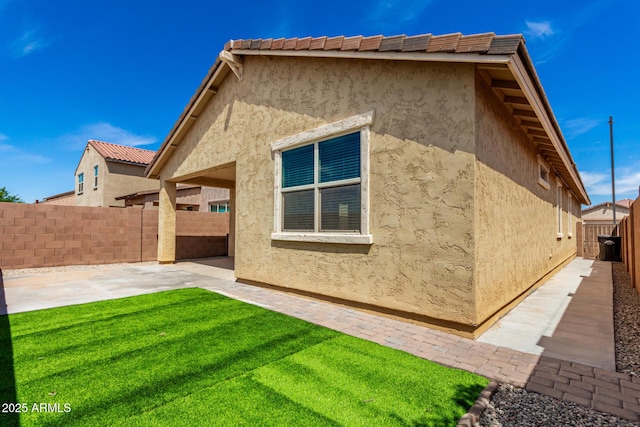 14355 W Valentine St, Surprise, AZ 85379 - back of property with a patio, a fenced backyard, a lawn, and stucco siding