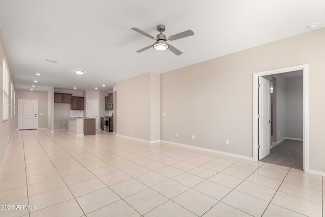 14355 W Valentine St, Surprise, AZ 85379 - unfurnished living room with recessed lighting, baseboards, ceiling fan, and light tile patterned flooring
