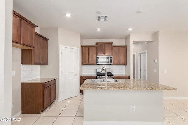 14355 W Valentine St, Surprise, AZ 85379 - kitchen featuring visible vents, a sink, appliances with stainless steel finishes, and backsplash